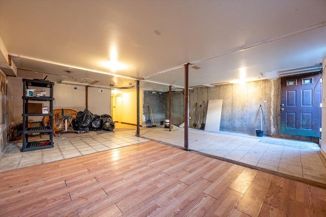 basement with light hardwood / wood-style floors