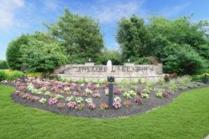 community / neighborhood sign with a lawn