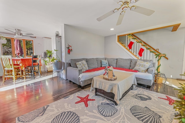 living room with wood-type flooring and ceiling fan