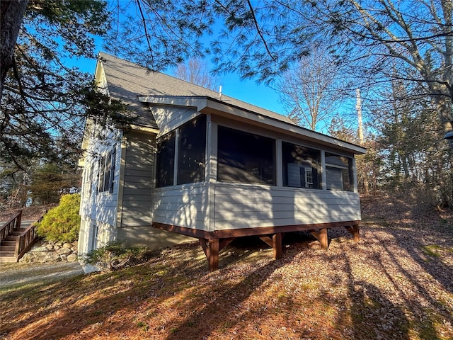 view of side of property featuring a sunroom