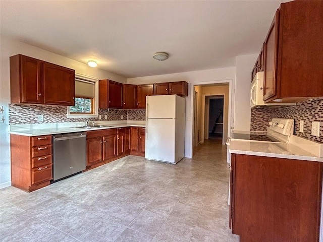 kitchen with white appliances, sink, and tasteful backsplash