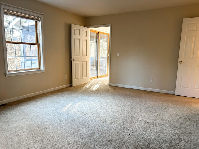 unfurnished room with light colored carpet