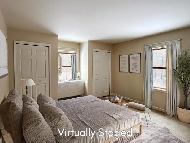 carpeted bedroom with multiple windows