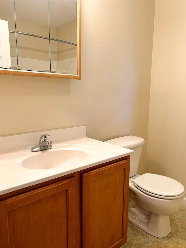 bathroom featuring tile patterned floors, vanity, and toilet