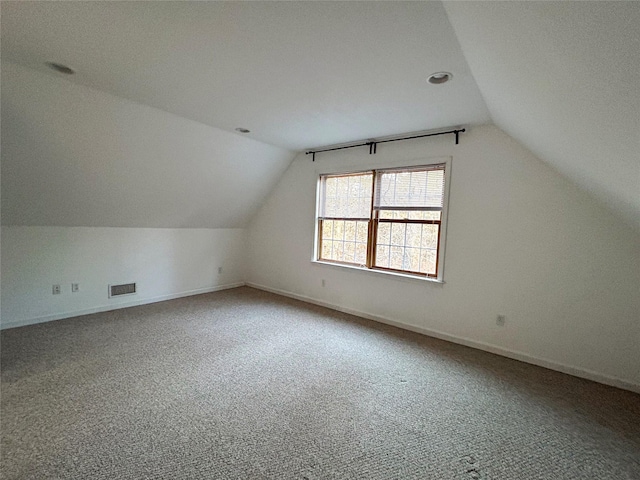 bonus room featuring a textured ceiling, carpet floors, and lofted ceiling