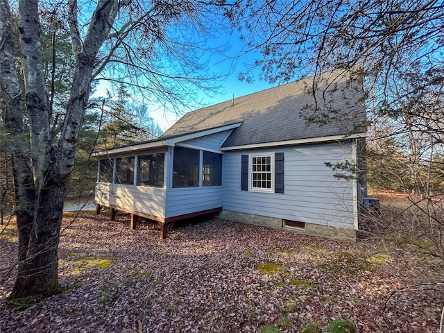 rear view of house featuring a sunroom