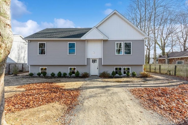 raised ranch featuring fence