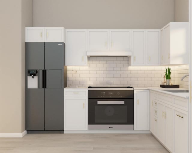 kitchen featuring decorative backsplash, stainless steel refrigerator with ice dispenser, stove, sink, and white cabinetry