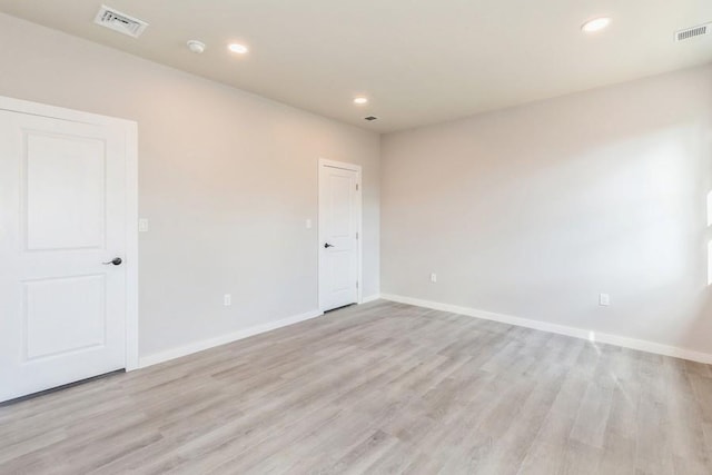 unfurnished room with light wood-type flooring