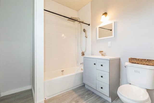 full bathroom with shower / bathing tub combination, vanity, hardwood / wood-style flooring, and toilet