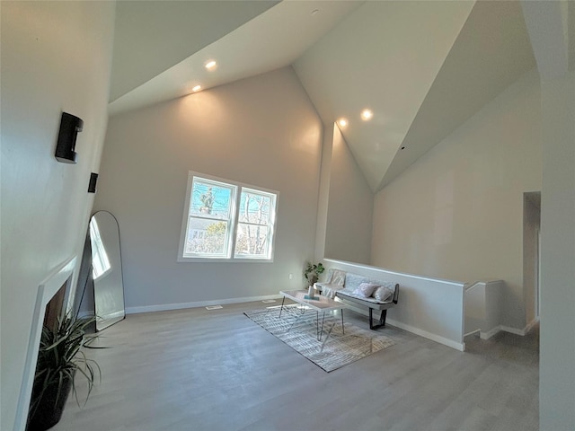 sitting room featuring high vaulted ceiling, recessed lighting, baseboards, and wood finished floors