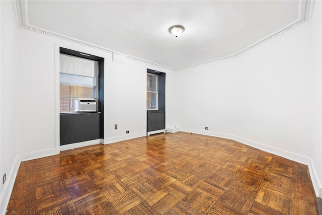 spare room with dark parquet floors and crown molding