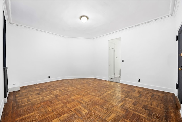 empty room with crown molding and parquet floors