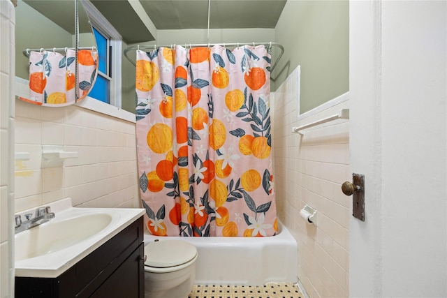 full bathroom with vanity, tile patterned flooring, toilet, tile walls, and shower / tub combo with curtain