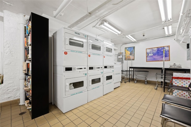 kitchen with white cabinetry, light tile patterned floors, and stacked washer and clothes dryer