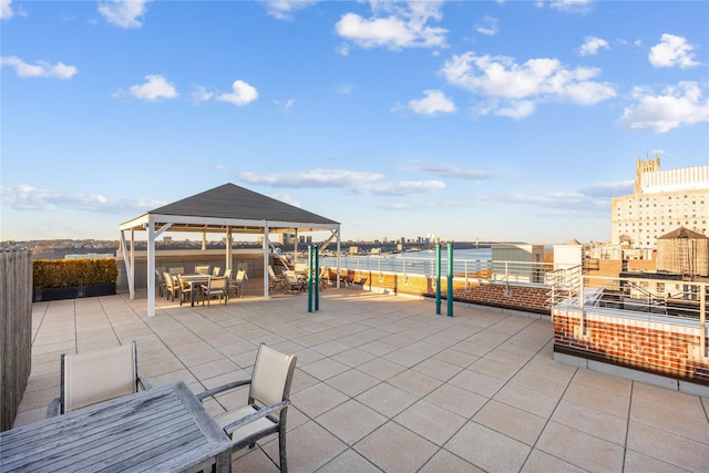 view of patio with a gazebo and a water view