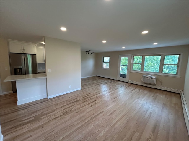 665 Pelham Rd Unit A15, New Rochelle, NY 10805 - unfurnished living room with baseboards, light wood finished floors, recessed lighting, and a baseboard radiator