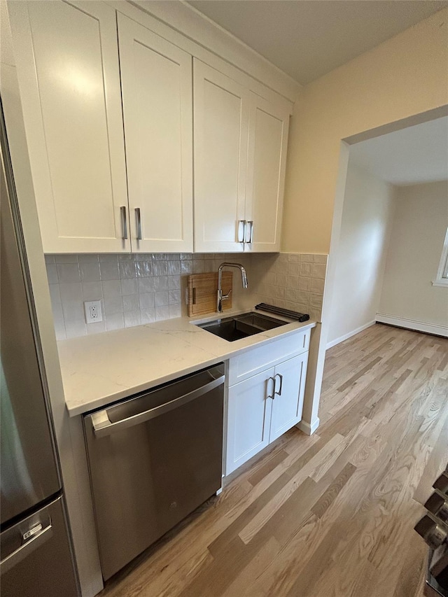 665 Pelham Rd Unit A15, New Rochelle, NY 10805 - kitchen featuring stainless steel appliances, a sink, light wood-style floors, and white cabinets