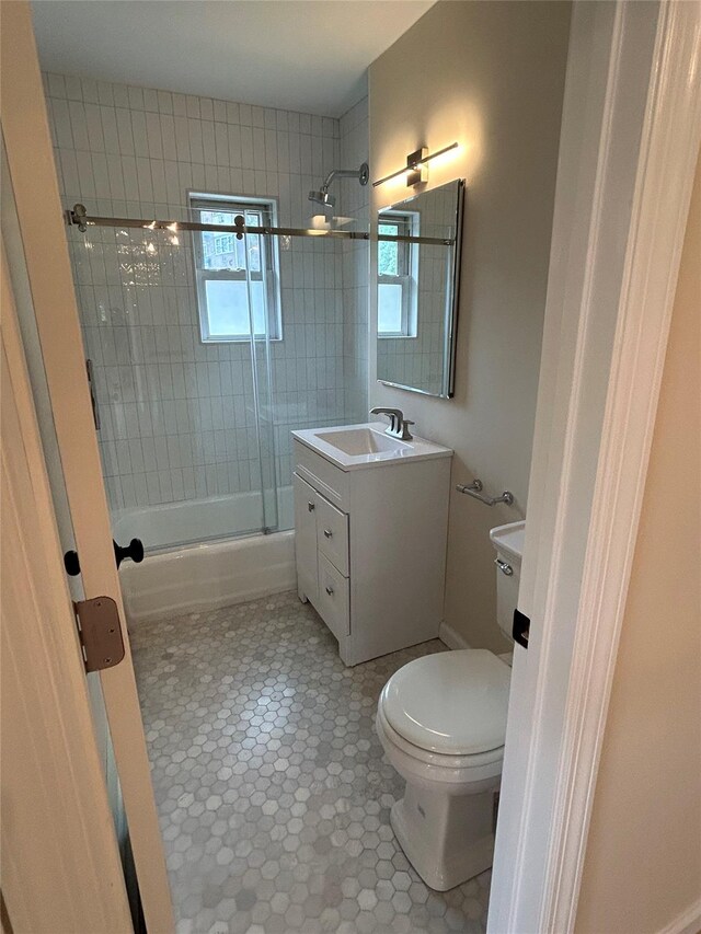 665 Pelham Rd Unit A15, New Rochelle, NY 10805 - bathroom with toilet, combined bath / shower with glass door, vanity, and tile patterned floors