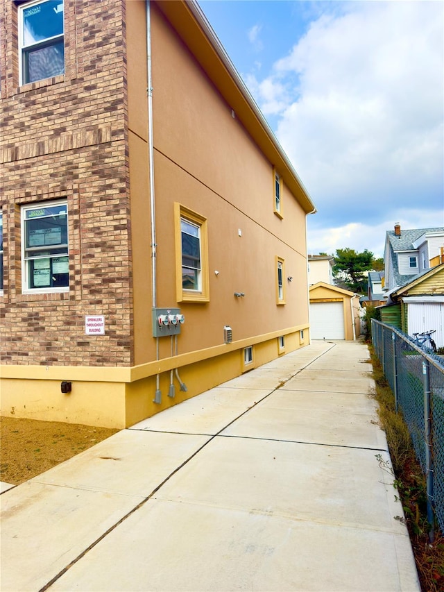 view of side of home with an outdoor structure and a garage