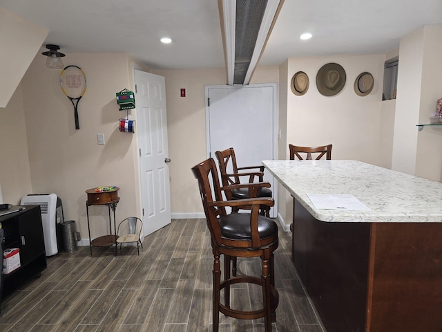 interior space with beamed ceiling and dark hardwood / wood-style floors