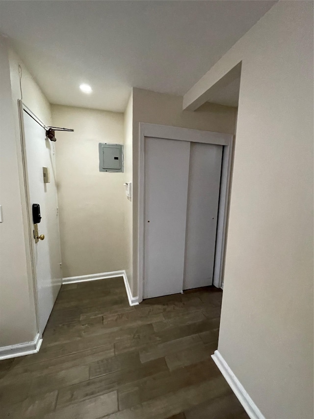 hallway featuring electric panel and dark hardwood / wood-style floors