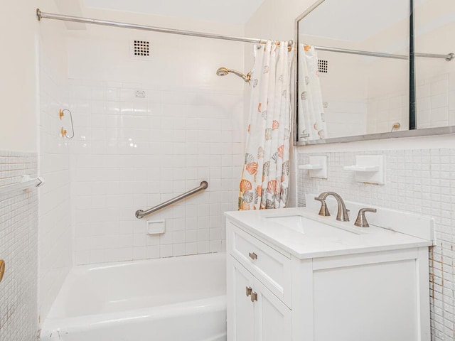 bathroom featuring vanity, shower / tub combo, and tile walls