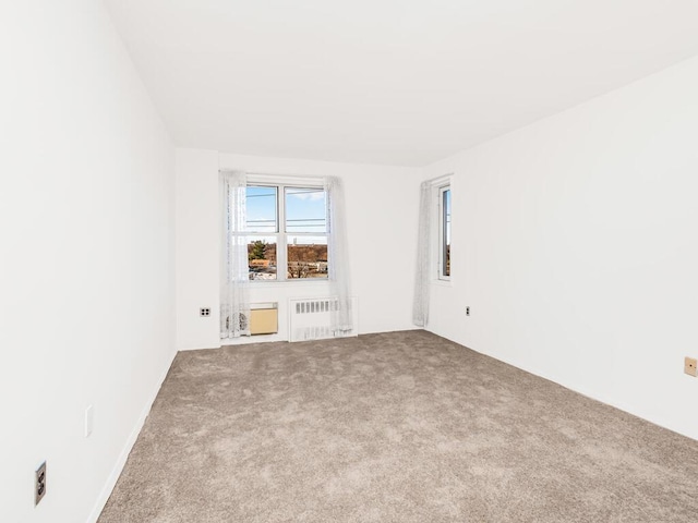 carpeted empty room with radiator heating unit