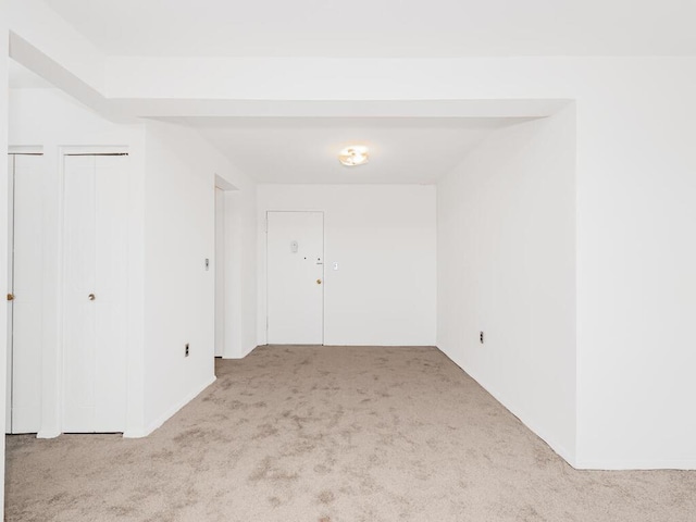 unfurnished room with light colored carpet