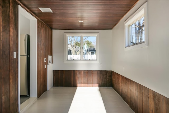 hall with wooden ceiling and wood walls