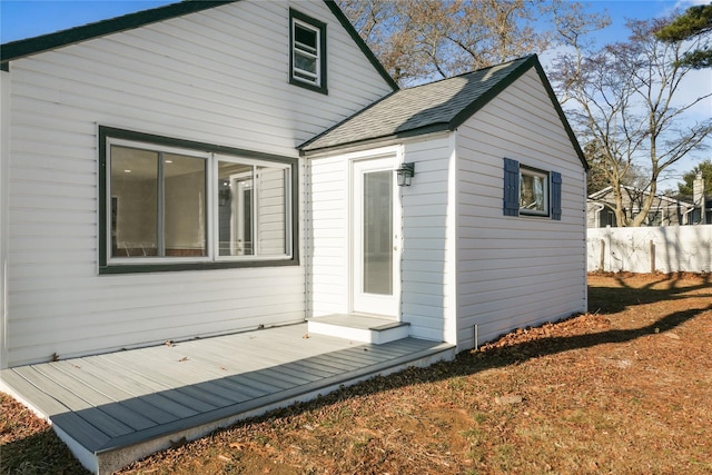 rear view of property featuring a wooden deck