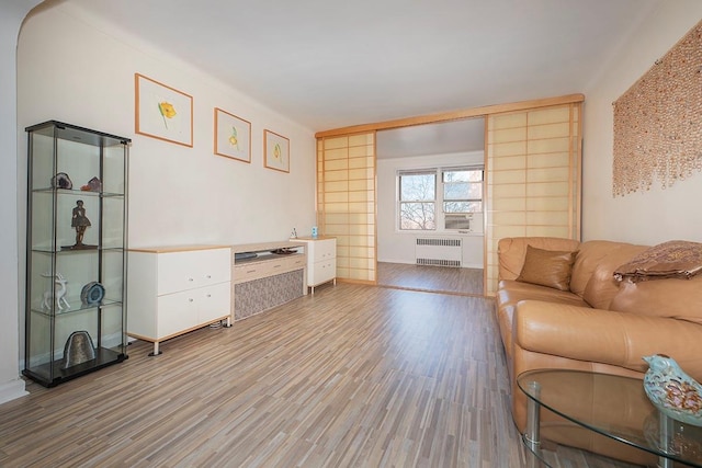 interior space featuring radiator heating unit and light wood-type flooring