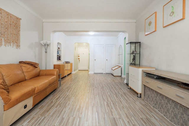 living room with light hardwood / wood-style floors and ornamental molding