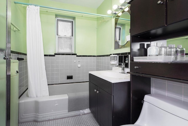 full bathroom featuring tile patterned floors, vanity, shower / bath combination with curtain, and tile walls