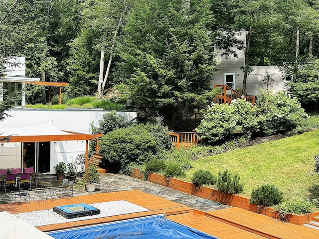 view of pool with a yard and a deck