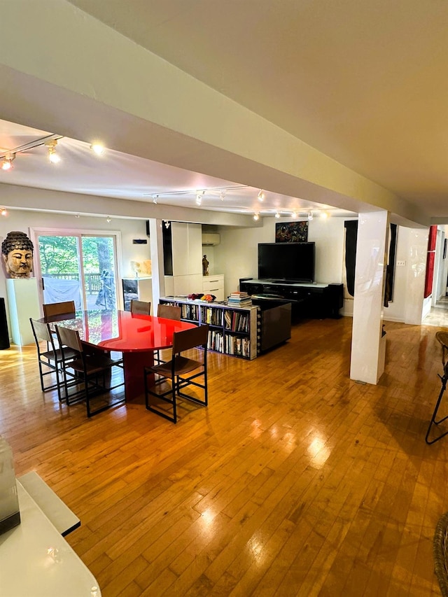 dining room featuring rail lighting and hardwood / wood-style flooring