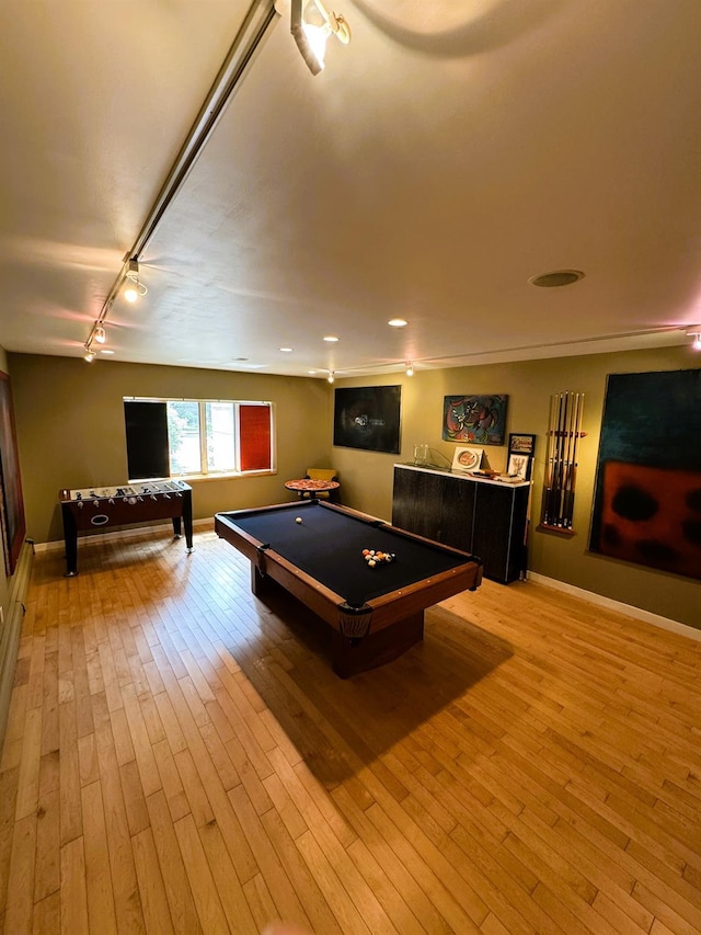 playroom with light hardwood / wood-style floors, rail lighting, pool table, and bar area