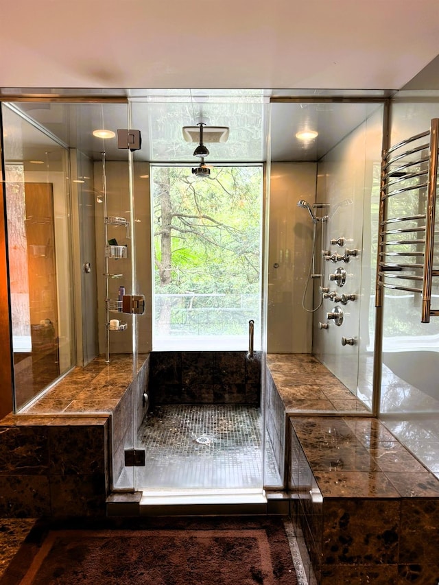 bathroom featuring radiator and a shower