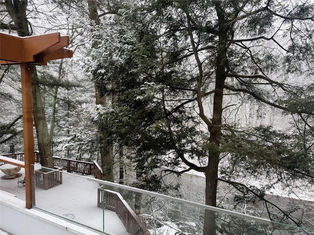 view of snow covered back of property