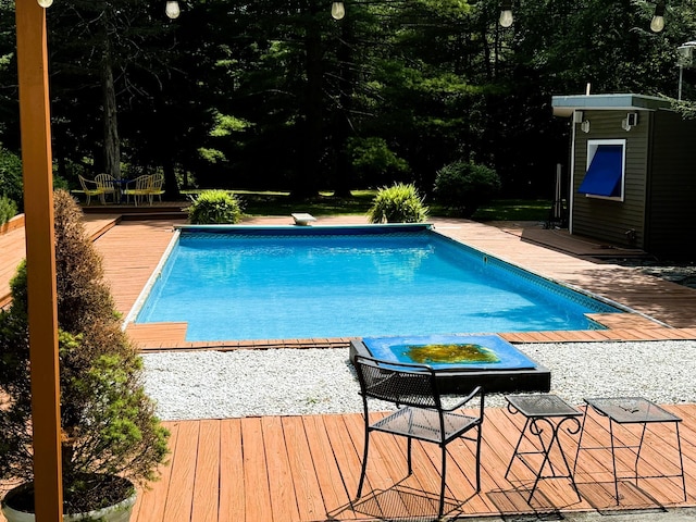 view of pool with a wooden deck