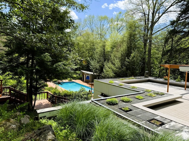 view of swimming pool featuring a deck