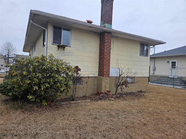 view of side of property with a lawn