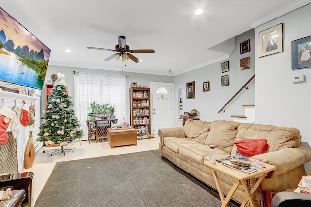 living room featuring ceiling fan, wood-type flooring, and crown molding