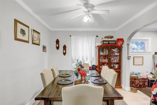 dining room featuring ceiling fan, light wood-type flooring, and ornamental molding