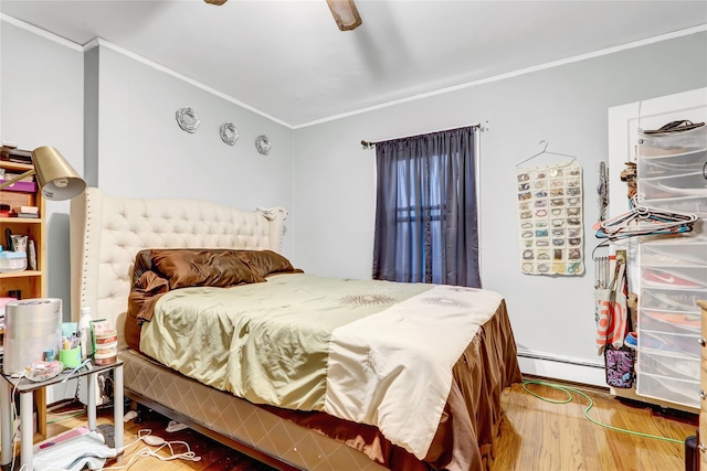 bedroom featuring hardwood / wood-style flooring, baseboard heating, ceiling fan, and crown molding