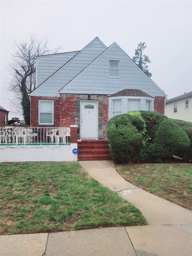 bungalow-style home featuring a front yard