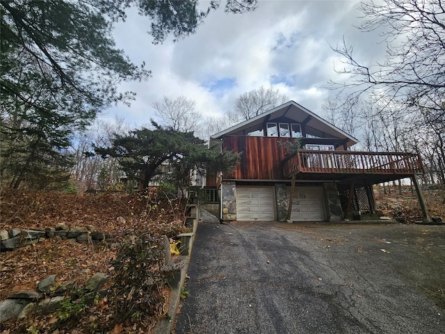 view of front of home with a garage and a deck