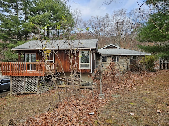 back of house featuring a wooden deck