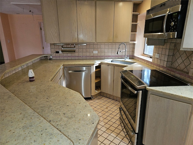 kitchen featuring decorative backsplash, light brown cabinetry, and appliances with stainless steel finishes