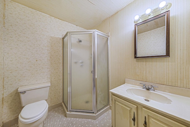 bathroom featuring tile patterned flooring, vanity, a shower with shower door, and toilet